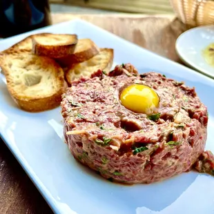 a steak tart with an egg on top