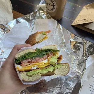 a person holding a sandwich in their hand