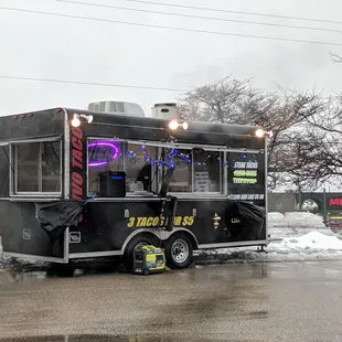 a taco truck parked in a parking lot