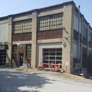 Turn into gravel lot before you get to 11th St to back of building.