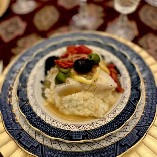 Sea bass filet with tomato olive confit on garlic herb mash potatoes
