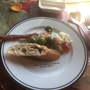 From the chefs antipasto board Spanish olives, a mixed goat cheese spread with black peppercorns, sausage and cherry tomatoes