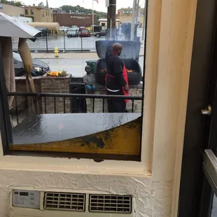 the reflection of a man in a window