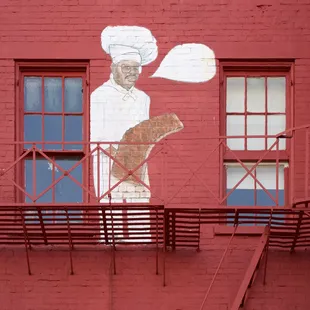 a chef on the side of a building