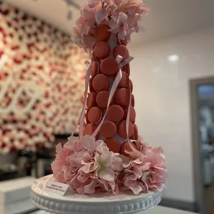 a tiered cake with pink flowers