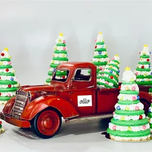 a red truck decorated with christmas trees