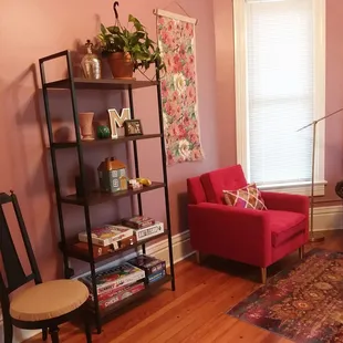 a living room with pink walls