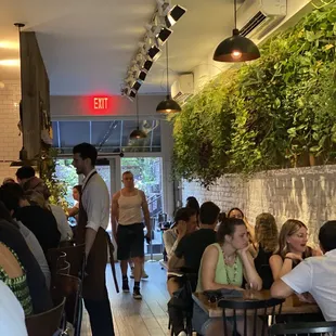 people sitting at tables in a restaurant