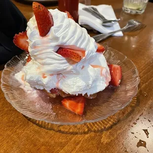 a strawberry shortcake with whipped cream and strawberries