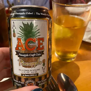 a person holding a can of beer