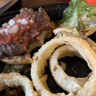 Burger was raw on the inside not medium rare and the onion rings were inedible.