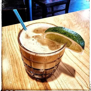 a drink with a lime slice on the rim