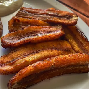 a plate of fried bacon