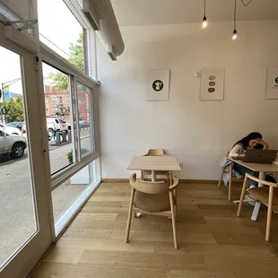 a person sitting at a table in a coffee shop