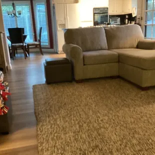 New floor and replaced furniture in family room looking into kitchen eating area