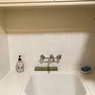 Completed cabinetry and tile in laundry room