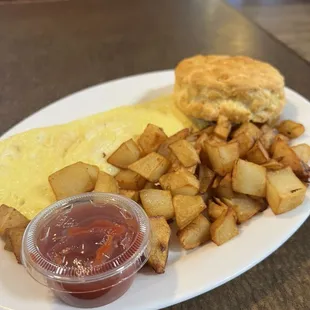 Cheese omelette chunky potatoes and biscuit.