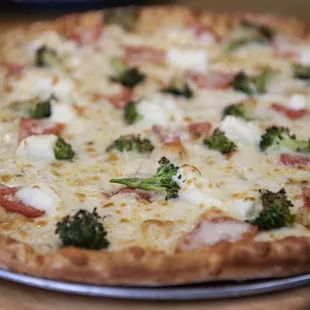 a pizza with broccoli and cheese