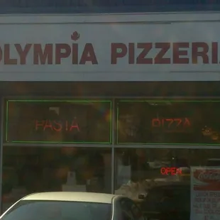 a car parked in front of a restaurant