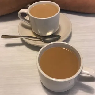 two cups of tea and a spoon