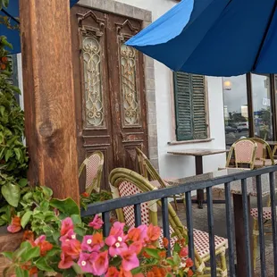 tables and chairs with umbrellas