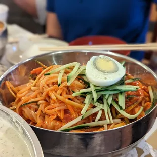 a bowl of noodles with a hard boiled egg