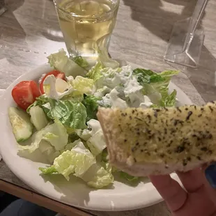 Bread, salad with creamy feta dressing, and a glass of Greek wine