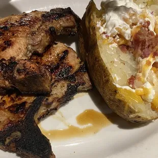 Grilled pork chops and loaded baked potato