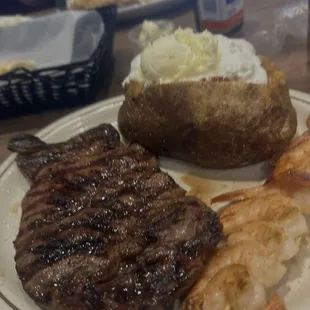Steak, shrimp  and loaded baked potato .