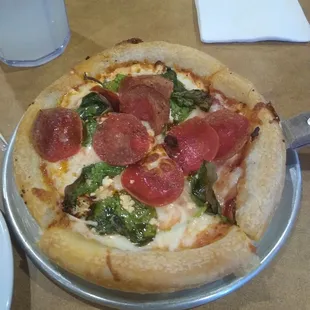 Personal pan pizza with Pepperoni, Spinach leaves and Feta Cheese.