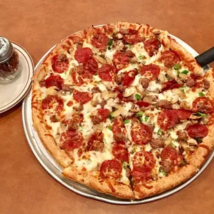 a pizza with pepperoni and sausage