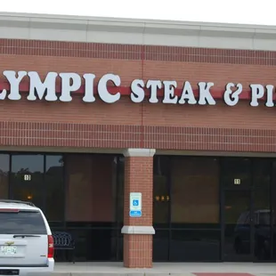 a car parked in front of a restaurant