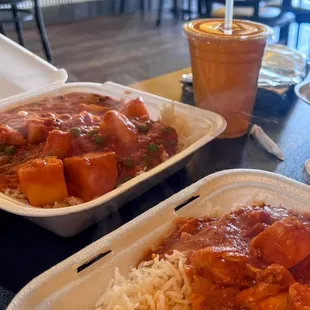two take out containers of food on a table