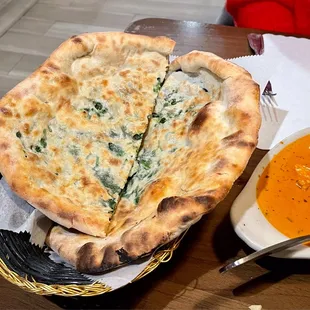 a bowl of soup and a flat bread