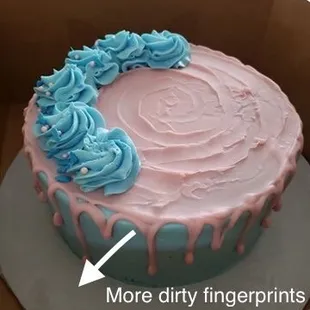 a pink and blue cake with icing