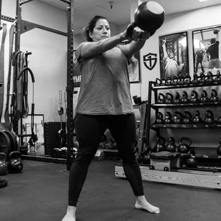 Becky swinging a 70lb Kettlebell and down 20 lbs in 7 weeks