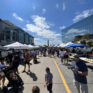 a crowd of people walking down the street