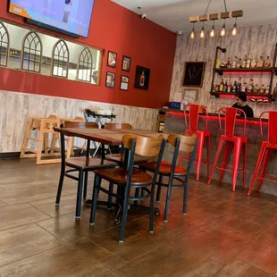 a bar with red chairs