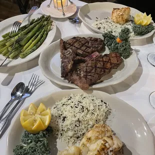 Almost our whole spread! Twin tail lobsters, porterhouse steak medium rare, asparagus, and mushrooms on the way!