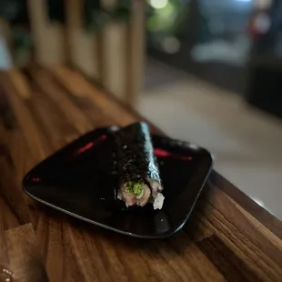 a black plate on a wooden table