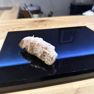 an omakase on a black plate