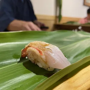 a closeup of a sushi on a banana leaf