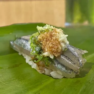 a close up of a sushi on a banana leaf