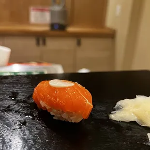 a sushi on a black plate