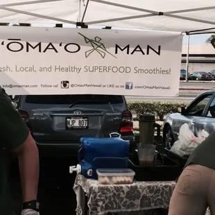 two men standing under a tent