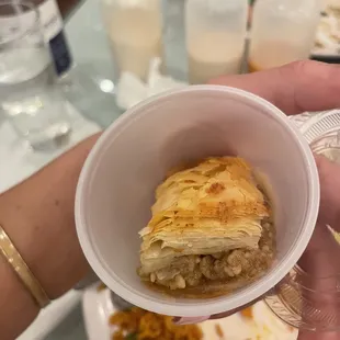 a person holding a bowl of food