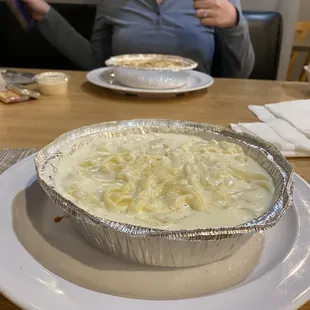 a woman sitting at a table with a pie