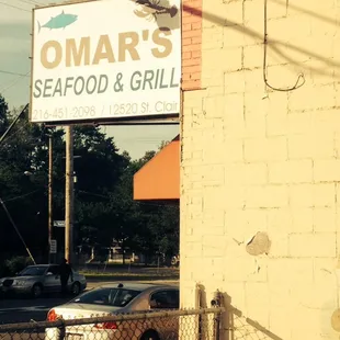 a sign for omar's seafood and grill