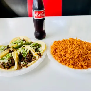 two plates of tacos and rice