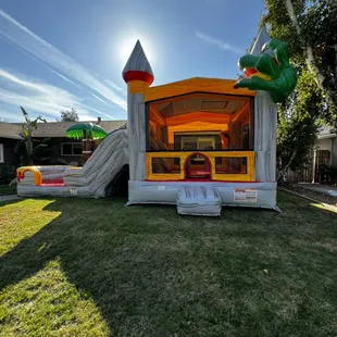 T-Rex wet/dry dual lane combo. Featuring pop ups, basket ball hoop, bounce area, two slides and a large pool.